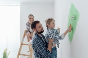 family painting their home with their kid