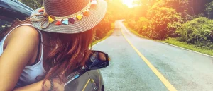 girl enjoying road trip at sunset